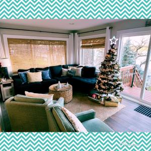 a living room with a christmas tree and a couch at The Lakeshore Cozy Cottage! in Wonder Lake