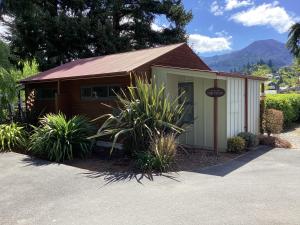 a small building with a sign in front of it at Hanmer Garden Suites in Hanmer Springs