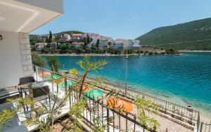 a view of the water from the balcony of a house at Apartments Villa Luce in Neum