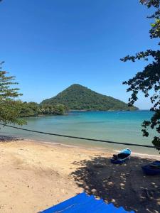 a beach with a boat sitting on the shore at ING ING GUESTHOUSE in Koh Rong Sanloem