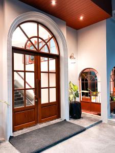an entrance to a house with a wooden door at SO Zen Hotel Silom Bangkok in Bang Rak