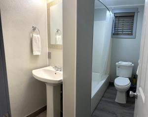 a bathroom with a sink and a toilet and a shower at Emerald Best Motel in Edmonds