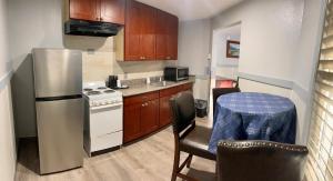 a small kitchen with a refrigerator and a table at Emerald Best Motel in Edmonds