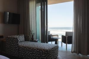a hotel room with a bed and a view of the ocean at Escape to the Beach in Wilderness