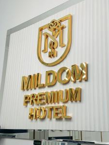 a sign on the side of a building with a million downyrinthyrinth hotel at Mildom Premium Hotel in Almaty