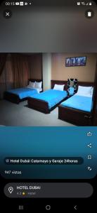 Una foto de dos camas en una habitación de hotel en Hotel Dubái en Catamayo