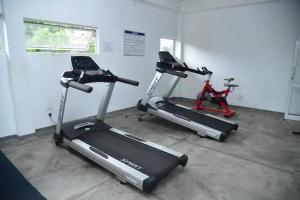 a gym with two exercise bikes and a treadmill at Cozy 2 bed 1 bath Apartment for rent in Homagama
