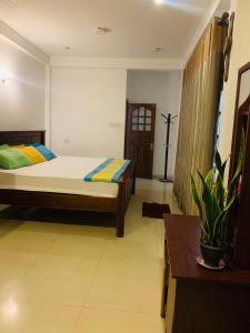 A bed or beds in a room at White Villa Ella/ Badulla