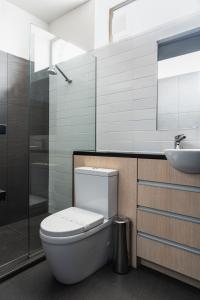 a bathroom with a toilet and a sink at New York Loft in Dunedin