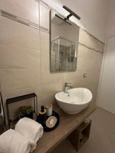 ein Bad mit einem Waschbecken und einem Spiegel in der Unterkunft B&B Le Chicche di Lulu' in Borghetto