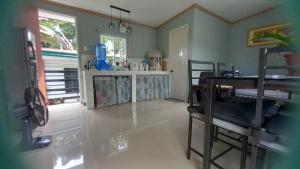 a kitchen with a table and a counter top at Baclayon, Bohol Cozy Furnished Studio in Tagbilaran City