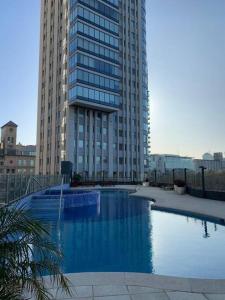 a large swimming pool in front of a tall building at Puerto Madero Apartamento Piso Entero de 650m2 Panorámico y Sofisticado in Buenos Aires