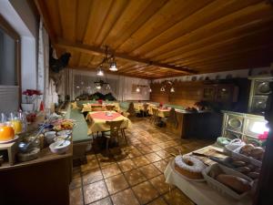 a large room with tables and chairs in a kitchen at Landhaus Wieser in Ramsau am Dachstein