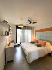a bedroom with a bed and a ceiling fan at La Kaz Leu tit'mer à 50 m du lagon de Saint-Leu in Saint-Leu