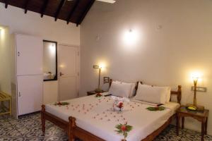 a bedroom with a large bed with christmas decorations on it at Chettinadu Court- HERITAGE VIEW in Kānādukāttān +49 photos