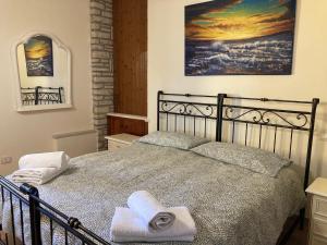 1 dormitorio con 1 cama con toallas en Casetta Perseo, en Cammarata