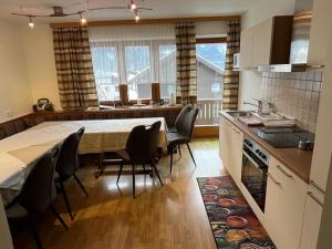 a kitchen and dining room with a table and chairs at Large holiday apartment for groups in Lengdorf near Niedernsill in Niedernsill