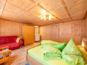 a room with a bed and a couch in it at Comfortable holiday home with garden in Voralberg in Sankt Gallenkirch