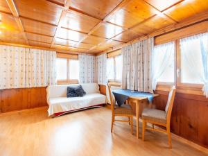 a living room with a couch and a table at Comfortable house with garden in Voralberg in Sankt Gallenkirch