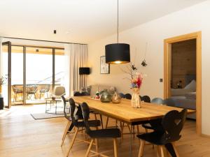 a dining room with a wooden table and chairs at Apartment in Schröcken near Ski Arlberg in Schröcken