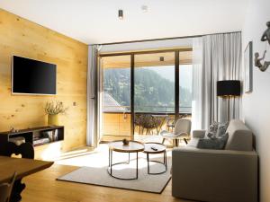 a living room with a couch and a table at Apartment in Schröcken near Ski Arlberg in Schröcken