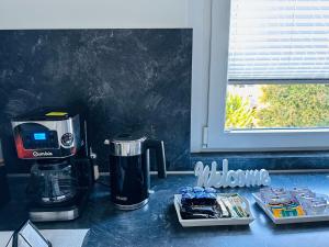 a coffee maker sitting on a counter next to a window at Ferienhaus in Warstein-Suttrop für 7 Personen in Warstein