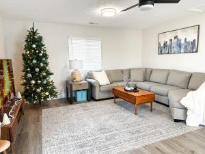 a living room with a christmas tree and a couch at Modern 3 bed 1 bath Home near downtown and UNL Lincoln in Lincoln