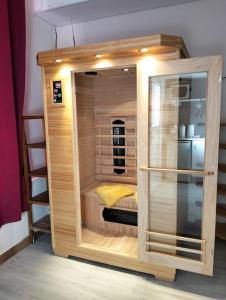 a small wooden cabin with a bed in it at la coquine, love room, romantique in Toulon