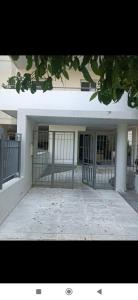 a building with a gate in front of it at Stavros Niarhos apartment in Athens
