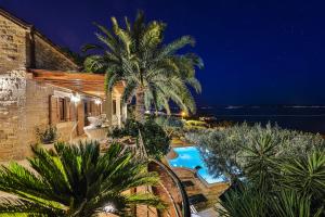 a villa with a swimming pool at night at Villa Tomislav in Split
