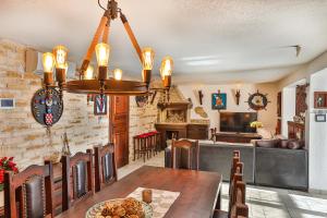 a dining room with a table and a chandelier at Villa Tomislav in Split