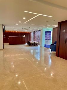 a lobby with a room with a table and a chair at Best Western Maharani Bagh New Delhi in New Delhi