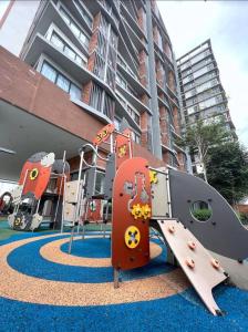 un parque infantil con un tobogán frente a un edificio en 2Bed For 4 // KLIA Sepang Xiamen University en Sepang