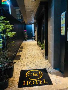a hotel sign on the floor of a hallway at C＆Jホテル in Tokyo