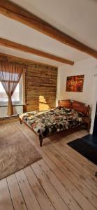 a bedroom with a bed in a room with wooden floors at Klajumi Countryside Cottages & Nature retreat in Kaplava +173 photos