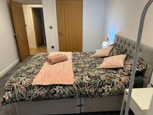 a bed with pillows on it in a room at Bedroom 2 in Elegant 3 Bed Flat in Ramsgate in Kent