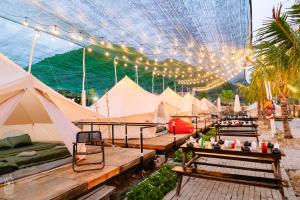 a group of tents with tables and lights at LALASEA BISTRO (Camping, Food & Drink) in Ha Tien