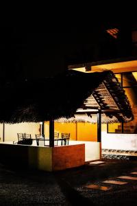 a group of tables and chairs under an umbrella at Villa Andaz in Negombo