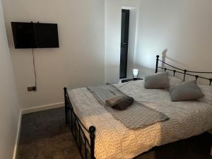 a bedroom with a bed with two pillows on it at Bedroom 3 in Elegant 3 Bed Flat in Ramsgate in Kent