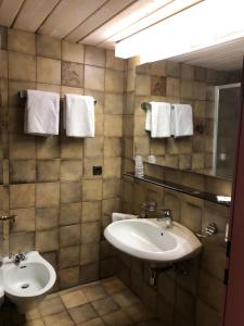 a bathroom with two sinks and a mirror and towels at B&B in Seefeld in Seefeld in Tirol