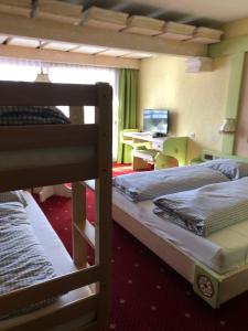 a bedroom with two bunk beds and a desk at B&B in Seefeld in Seefeld in Tirol