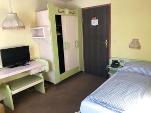 a bedroom with a bed and a desk with a television at B&B in Seefeld in Seefeld in Tirol