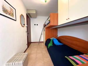 a small room with a bunk bed and a staircase at Residenza Porta Del Mare in Lignano Sabbiadoro
