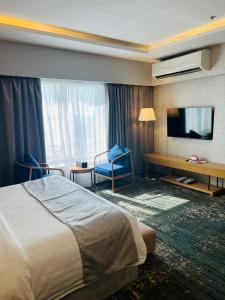 Habitación de hotel con cama y TV en سكوب العربية en Yeda