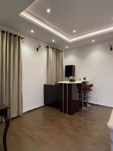 an office with a desk and a table in a room at Fedora Luxury Villa in Lekki Phase 1 in Lekki