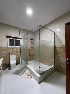 a bathroom with a shower and a toilet at Fedora Luxury Villa in Lekki Phase 1 in Lekki