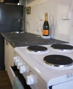 a bottle of wine sitting on top of a kitchen stove at Seascape Retreat - Time to Slow Down - Suits Couples or Family with Kids with 2 sleeping spaces in Agnes Water