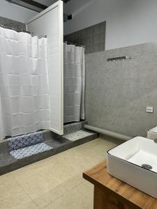 a bathroom with a sink and a shower at Hostel O2 in Almaty