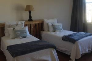 En eller flere senge i et værelse på Belmont Farm Cottage