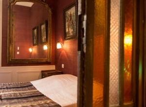 a bedroom with a bed and a mirror at La Petite Calanque in Marseille